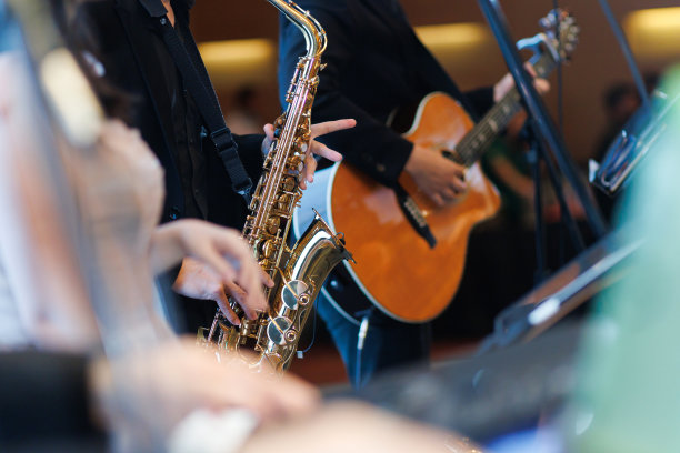 萨克斯手和吉他手在舞台上一起表演歌曲特写图片下载