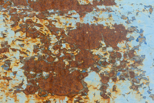 锈迹斑斑的蓝色金属墙，油漆掉落，背景生锈。图片下载