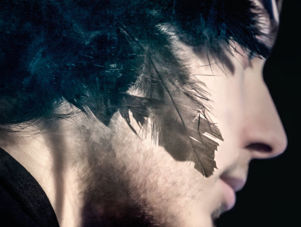 头发上插着羽毛的年轻男子肖像图片下载