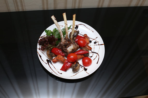 美味的开胃菜鸟肋配蔬菜和西红柿在餐厅的盘子里图片下载