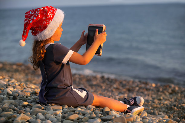 小女孩在圣诞节的节日里在海边进行了一次温暖的旅行图片下载