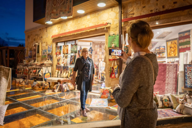 成年母亲和女儿在晚上的旅行中拍照图片下载