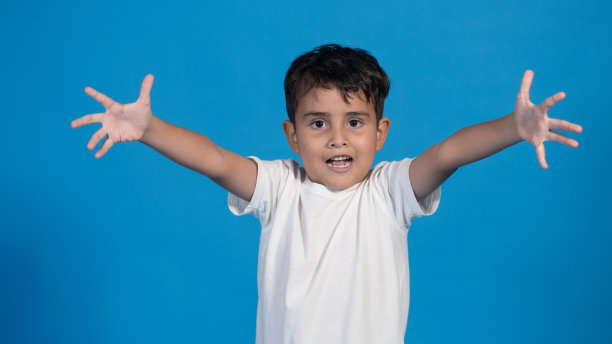 蓝色背景的快乐孩子，张开双臂给了一个拥抱图片下载