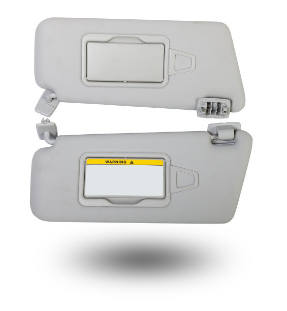 在照相馆用白色背景的浅灰色塑料制成的镜子遮阳板。在汽车维修中供更换或在汽车拆解时出售的汽车内饰备件。图片下载