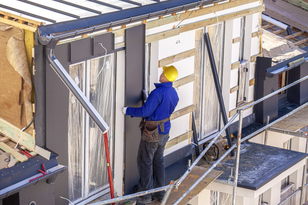 屋顶工人将板材安装在立面上图片下载