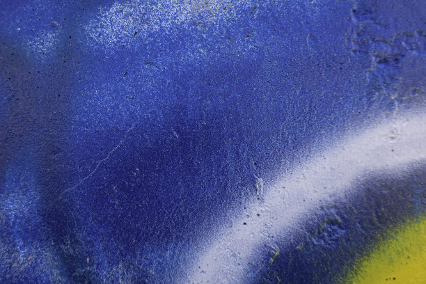 墙上的涂鸦碎片。部分彩色街头艺术涂鸦在墙壁背景图片下载