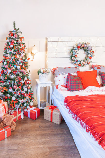 经典的室内房间有圣诞树和传统的白红色装饰。现代干净的白色古典风格室内设计公寓卧室。平安夜在家。简约的家居设计。图片下载