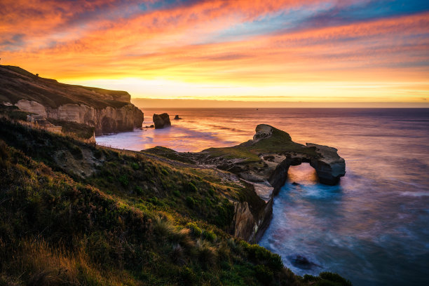 日落时分新西兰达尼丁隧道海滩的美丽照片图片下载