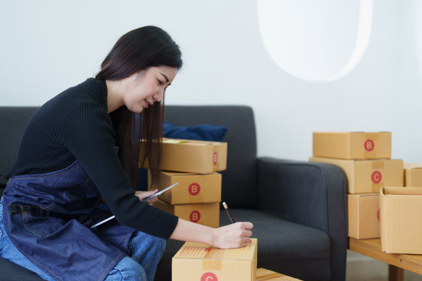 创业小型企业的自由职业亚洲女性微笑和使用平板电脑与开朗成功项目在线营销包装盒和配送中小企业的想法概念图片下载