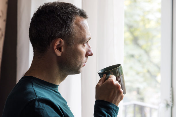 侧面画像年轻的成年白人男子与咖啡图片下载