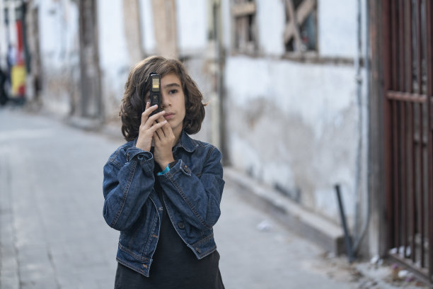 使用老式胶片相机的男小学生肖像图片下载