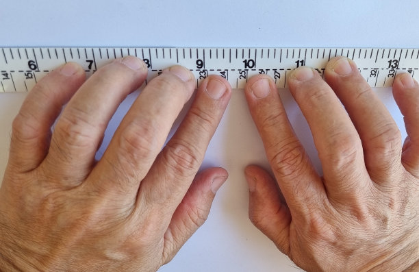 手拿塑料尺子在白纸上工作的特写照片图片下载