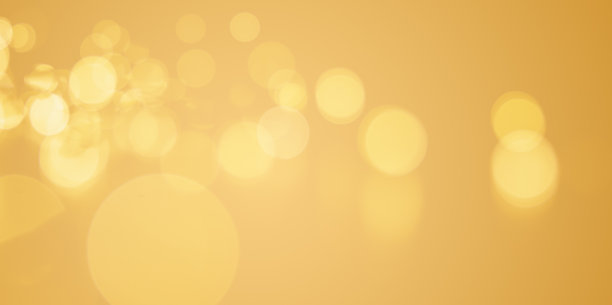 明亮的金色背景与散景闪闪发光的灯光。金色装饰质地，适合香槟色的庆祝活动。金色气泡与复制空间的横幅设计图片下载