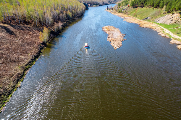船只航行的河的无人机视图。秋游江边，树傍岸边图片下载