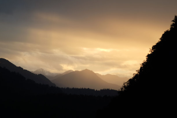 夕阳下多云天空的山脉剪影图片下载