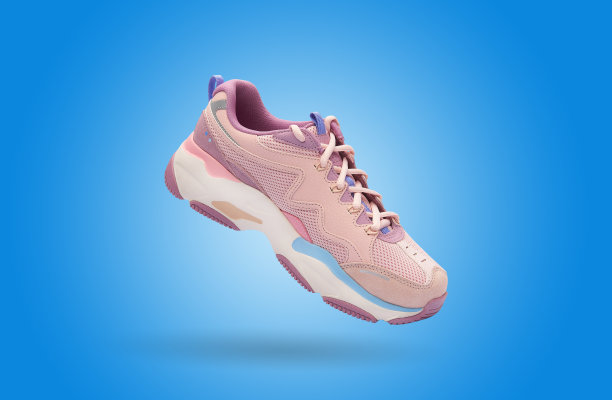 在彩色背景上飞行的彩色女子运动鞋。生活方式产品照片，悬浮和城市风格概念。图片下载
