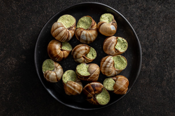 蜗牛配欧芹黄油，勃艮第蜗牛盘蜗牛。Delikatese食物。图片下载