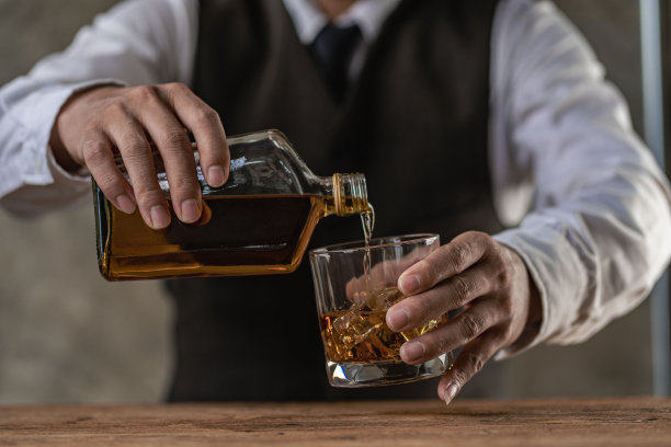 拿着威士忌酒杯的严肃商人的特写展示了行政特权的概念。软的焦点。两个男人戴着正装威士忌酒杯的特写镜头。图片下载