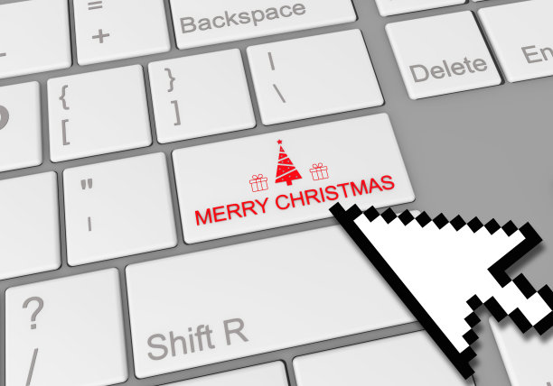 鼠标点击笔记本电脑键盘上一个特殊的“圣诞快乐”按钮图片下载