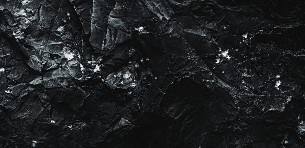 黑色的纹理。石头的背景。黑暗的大理石。岩石纹理。岩石表面有裂缝。岩石堆。墙漆点。枯燥乏味的粗糙结构。抽象的纹理。图片下载