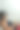 垂直拍摄的卷发黑发高级妇女戴着虚拟现实眼镜和手持游戏机控制器，而躺在沙发上。图片下载