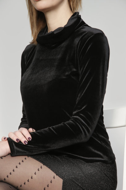 一系列女模特的工作室照片，穿着毛绒黑色高领毛衣，闪亮的黑色紧身裙，深开叉和心形印花半透明紧身裤，简单而有效的节日着装图片下载