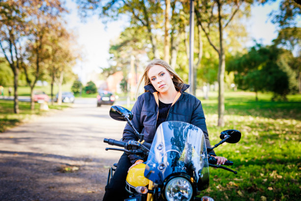 秋天公园的女摩托车手准备骑行图片下载