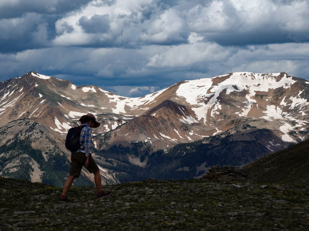 科罗拉多大陆分水岭高处的成熟女子徒步旅行者。远处的无夏山上空乌云密布。图片下载