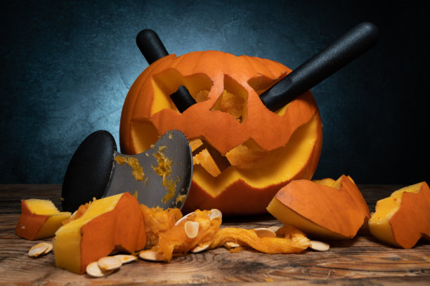 万圣节雕刻南瓜和雕刻工具套装为南瓜灯的脸切割出来。图片下载