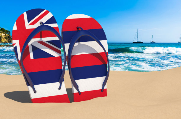沙滩上有夏威夷国旗的人字拖。夏威夷度假村，度假，旅游，旅游套餐概念。三维渲染图片下载