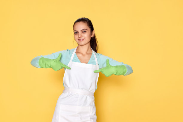 戴着手套的微笑白人妇女用手指指着自己图片下载