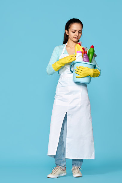 妇女戴手套和清洁围裙与清洁用品图片下载