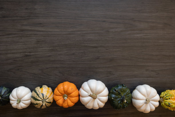 在深色的木头上装饰迷你南瓜和葫芦图片下载