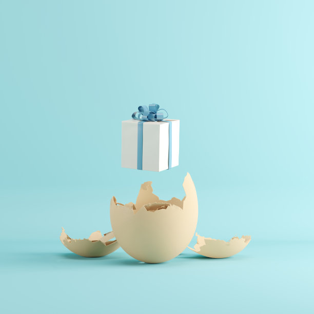 白色礼品盒与蓝色丝带鸡蛋在黄色的背景。图片下载