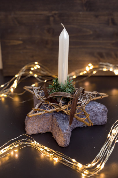 用云杉做的圣诞装饰，木制背景上有蜡烛。软焦点图片下载