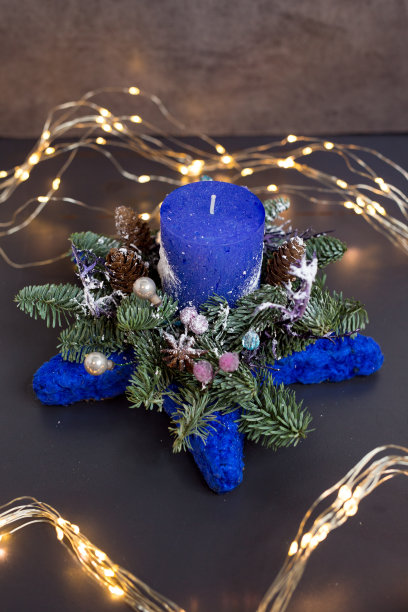 圣诞装饰用蜡烛，蓝色的球，冷杉在田庄背景。软焦点图片下载