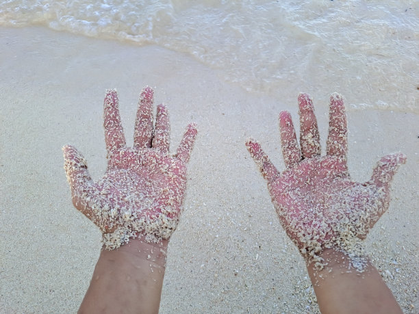 手与沙粒沙滩图片下载