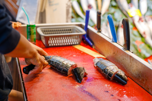 渔民清理市场上的海鱼。餐厅里的厨师在切鱼。寒冷地区的新鲜食品图片下载