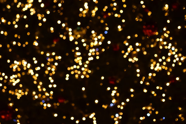 黑色背景上的金色散焦圆。覆盖。图片下载