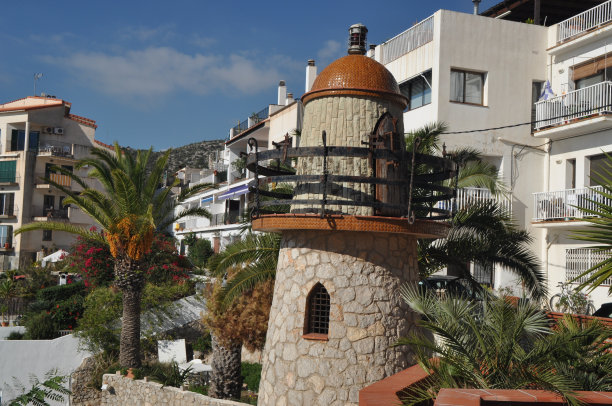 阳光明媚的风景，美丽的公园建筑附近的棕榈树图片下载