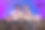 年轻有吸引力的亚洲女人在家里霓虹灯照明的客厅玩电子游戏。一对情侣在同一工作站前工作的侧视图。图片下载