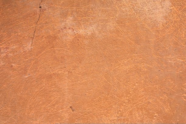 橙色墙在户外。背景图片。喘息老化混凝土表面与陶土灰泥样本。壁纸的图片。前视图。图片下载