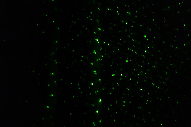 激光在黑暗。黑色背景上的绿色光线。太空中的激光辐射。图片下载