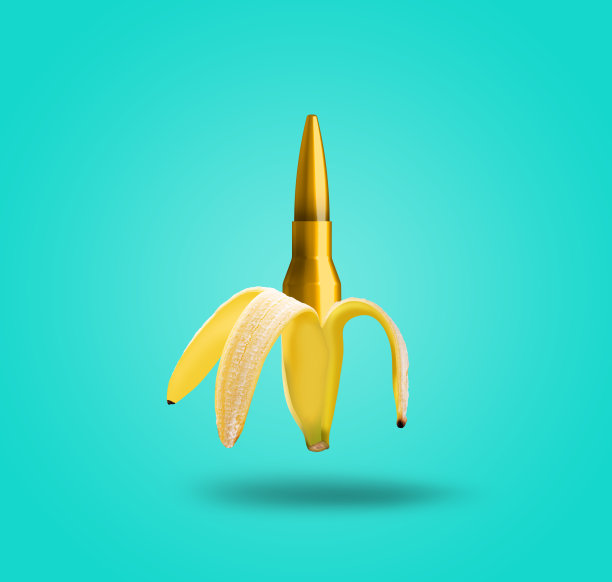 当代艺术拼贴。一颗子弹和一根香蕉。现代食品的概念。图片下载