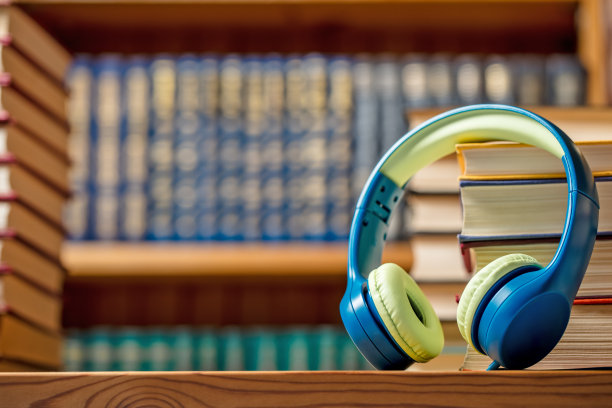 有声书的概念-在图书馆有一堆书的耳机图片下载