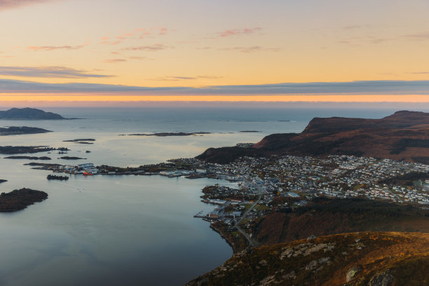 凝视着海上的日落和挪威山上岛屿上的小镇图片下载