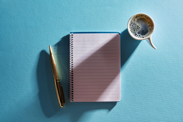 空白便条杯咖啡和金色钢笔在蓝色背景下图片下载