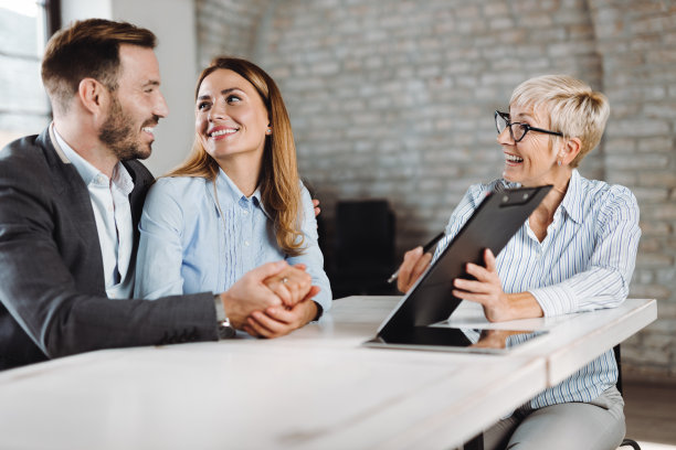 一对幸福的夫妇在会议上与保险代理人交谈图片下载