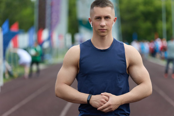 肌肉发达的运动员穿着运动衫，赛后在体育场向球迷摆姿势图片下载