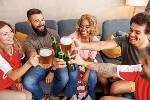 球迷们一边喝着啤酒一边看电视上的比赛图片下载